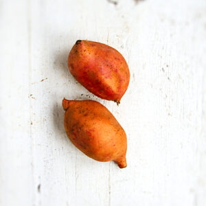 Fresh Kumara Orange Jumbo potatoes arranged on a kitchen counter