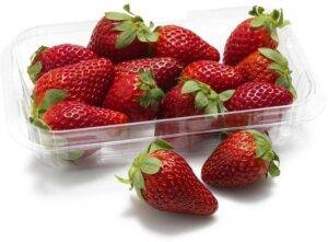 A close-up of ripe fresh strawberries, glistening with dew